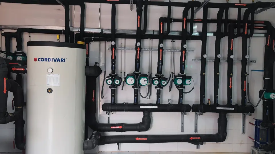Plant room built by Kabil Clim: hot water tank, circulator pumps and insulated manifolds